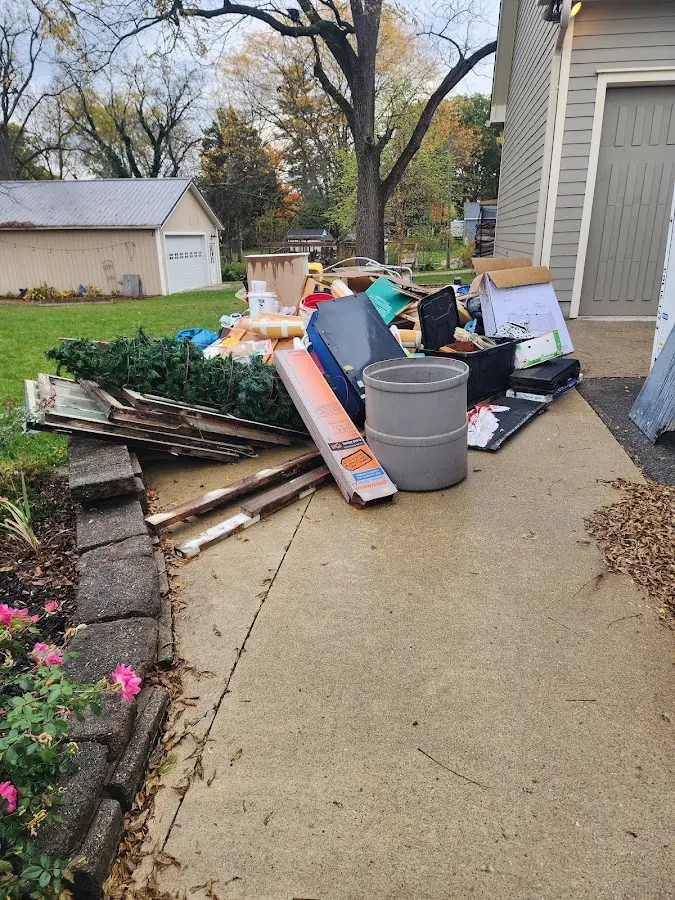 Dumpster being loaded with debris for Residential Dumpster Rental in Longview